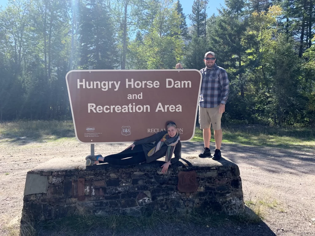 Husband and wife in front of the Hungry Horse Dam sign