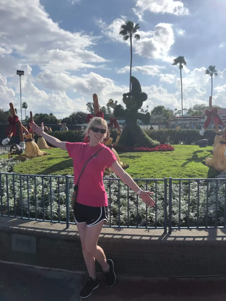 Standing in front of Mickey Mouse lawn art at Christmas