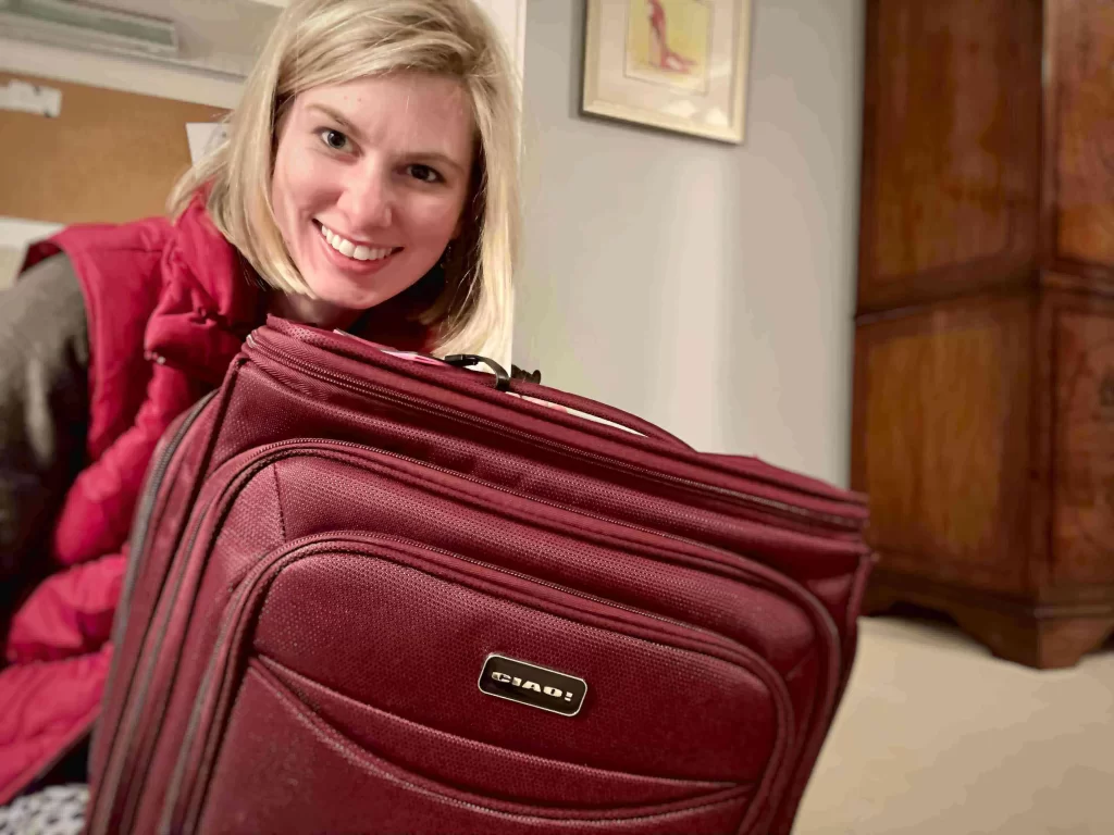 Girl holding the Ciao Underseat Bag (the best underseat bag), prior to it being expanded