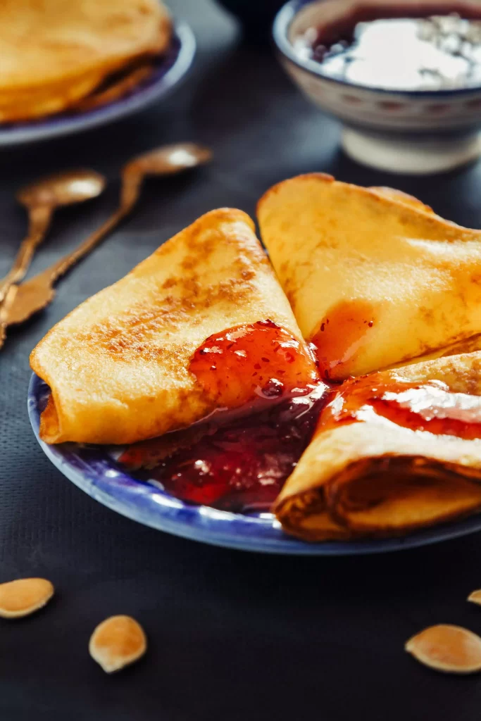 Crepe with raspberry topping on a plate 