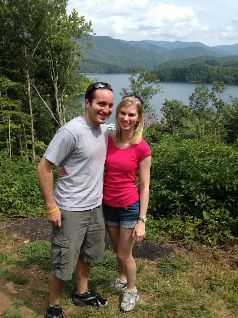 Husband and wife standing in front of Appalachian Mountains