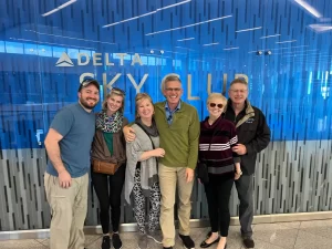 Family standing in front of Delta SkyClub