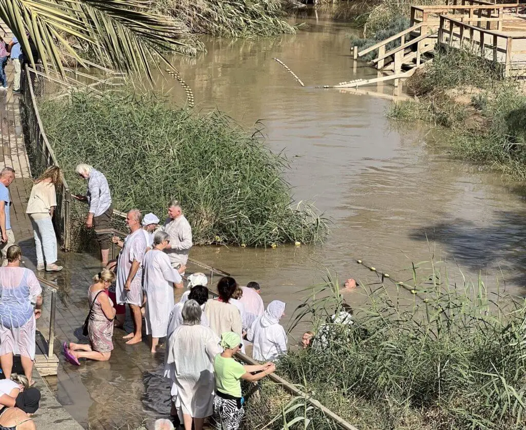 People getting baptized in the Jordan River