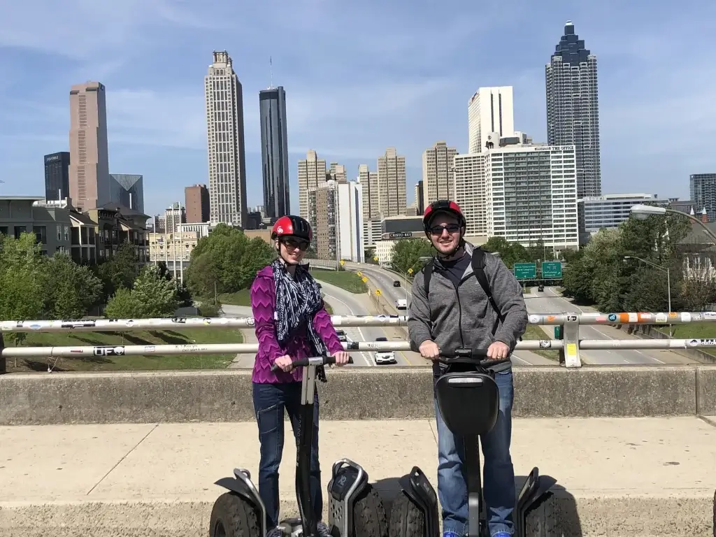 Husband and I posing for photo on segways in downtown Atlanta, Georgia