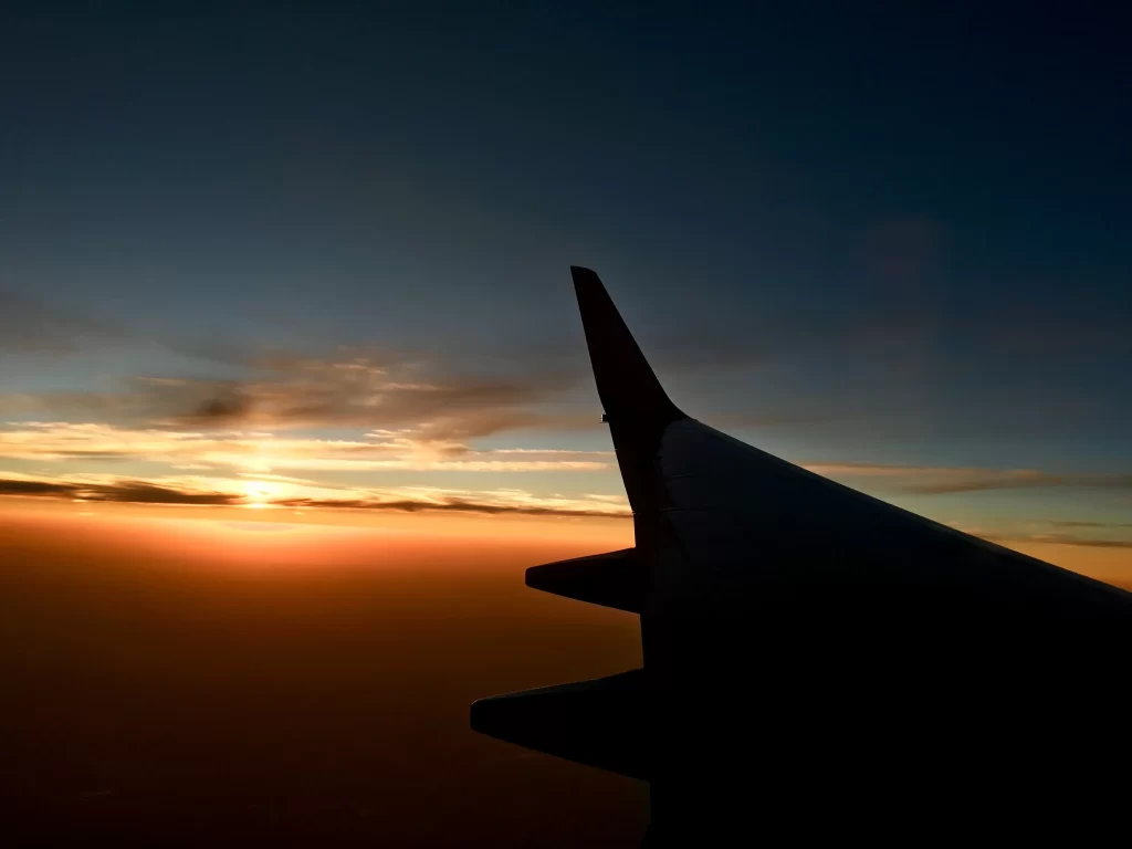 wing of a plane during sunset