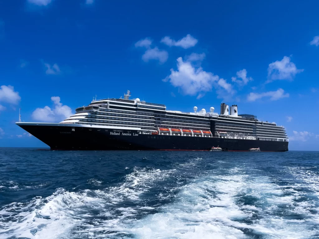 Picture of Holland America Cruise Ship with clear blue skies and some clouds in the background