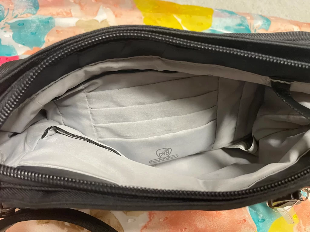 Inside look of a black classic mini Travelon crossbody bag